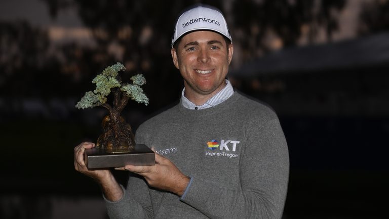 Luke List holds up the championship trophy after winning the the Farmers Insurance Open golf tournament. (Denis Poroy/AP)