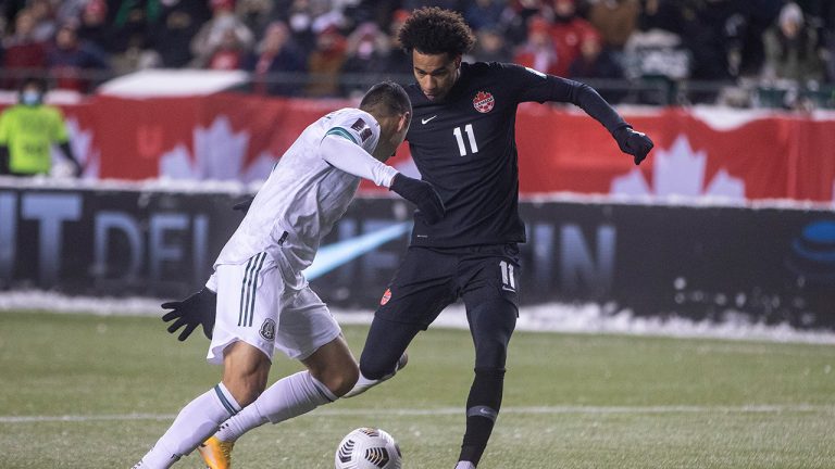 Canada's Tajon Buchanan (11) and Mexico's Julio Cesar Dominguez Juarez (3) via for the ball during World Cup Qualifiers in Edmonton, Tuesday, Nov. 16, 2021. (Jason Franson/CP)