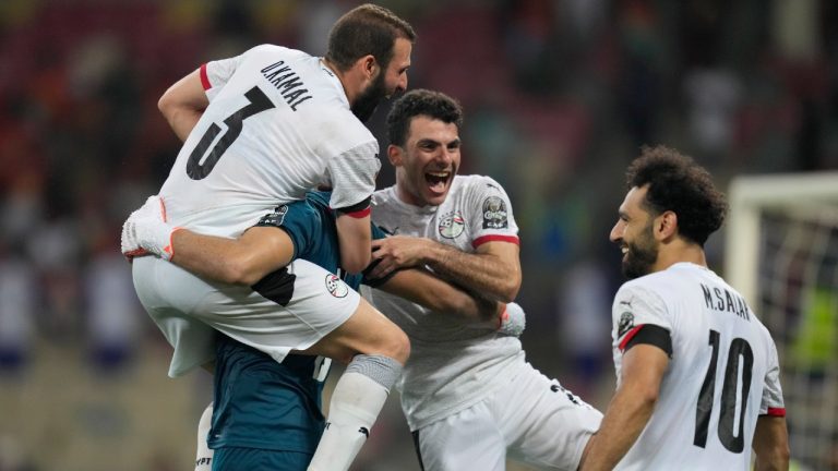 Egypt's captain Mohamed Salah, right, celebrates with teammates after scoring the winning penalty for the African Cup of Nations 2022 round of 16 soccer match between Ivory Coast and Egypt at the Japoma Stadium in Douala, Cameroon, Wednesday, Jan. 26, 2022. Egypt beat Ivory Coast 5-4 on penalties. (Themba Hadebe/AP) 
