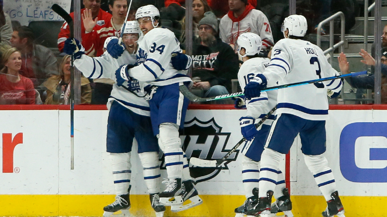 Toronto Maple Leafs left wing Michael Bunting, left, celebrates with center Auston Matthews (34), right wing Mitchell Marner (16) and defenseman Justin Holl (3) after scoring his third goal of the game Saturday against the Detroit Red Wings, Jan. 29, 2022, in Detroit. (AP)