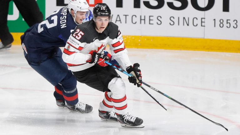 Canada's Owen Power, right, challenges for the puck with Tage Thompson of the US during the Ice Hockey World Championship semifinal match between the United States and Canada at the Arena in Riga, Latvia, Saturday, June 5, 2021. (Sergei Grits/AP)