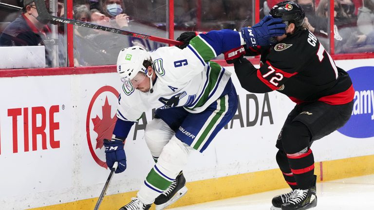 Vancouver Canucks centre J.T. Miller (9) shoves his glove in the face of Ottawa Senators defenceman Thomas Chabot (72) during third period NHL action. (Sean Kilpatrick/CP)