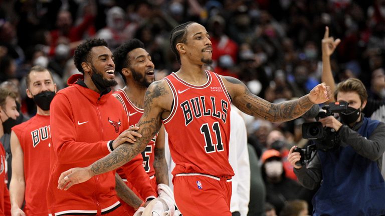 Chicago Bulls forward DeMar DeRozan (11) reacts with teammates after he made a three-point basket at the buzzer at the end of an NBA basketball game against the Washington Wizards. (Nick Wass/AP)