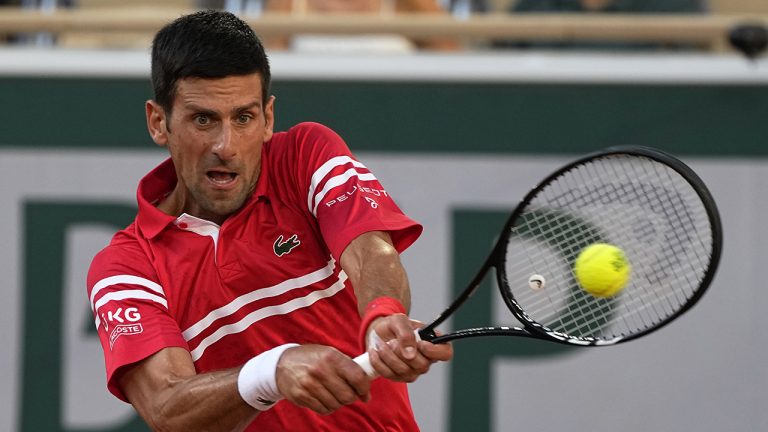 Serbia's Novak Djokovic returns the ball to Spain's Rafael Nadal during their semifinal match of the French Open tennis tournament at the Roland Garros stadium. (Michel Euler/AP)