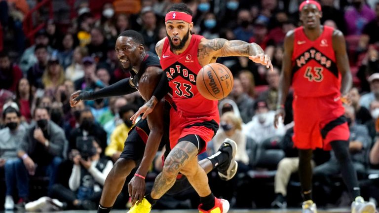 Miami Heat center Bam Adebayo, left, loses control of the ball as Toronto Raptors guard Gary Trent Jr. (33) defends during the first half of an NBA basketball game, Saturday, Jan. 29, 2022, in Miami. (Lynne Sladky/AP) 