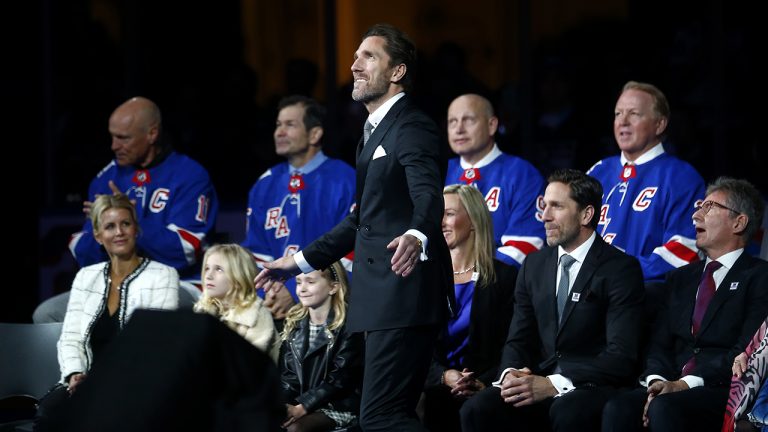 Former New York Rangers goaltender Henrik Lundqvist, centre, watches as his number is retired before an NHL hockey game between the Rangers and the Minnesota Wild. (AP)