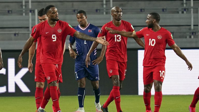 Canada forward Cyle Larin (9) after a second goal against Bermuda with midfielder Atiba Hutchinson (13) and forward Junior Hoilett (10). (John Raoux/AP)