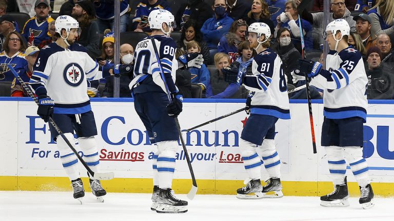 Members of the Winnipeg Jets pause after scoring an empty net goal during the third period of an NHL hockey game against the St. Louis Blues. (Scott Kane/AP)