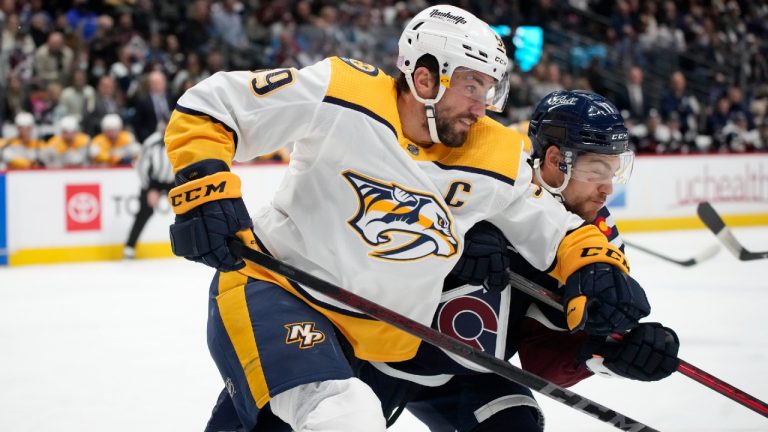 Nashville Predators defenseman Roman Josi, front, collides with Colorado Avalanche left wing Tyson Jost in the first period of an NHL hockey game Saturday, Nov. 27, 2021, in Denver. (David Zalubowski/AP) 