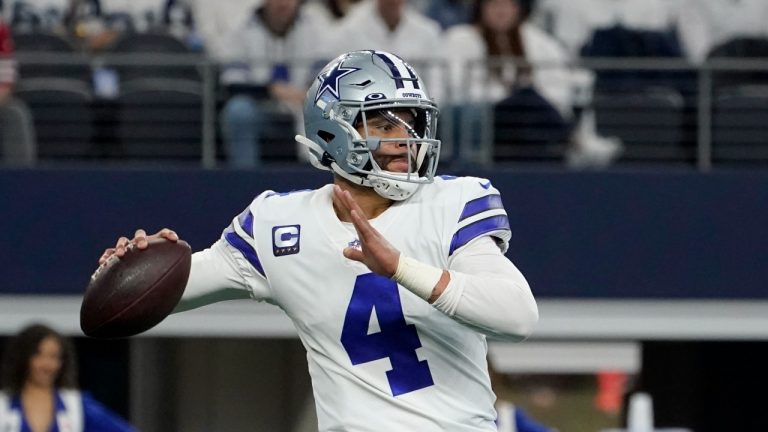 Dallas Cowboys quarterback Dak Prescott (4) looks before throwing a pass in the first half of an NFL wild-card playoff football game against the San Franciso 49ers in Arlington, Texas, Sunday, Jan. 16, 2022. (Tony Gutierrez/AP Photo) 
