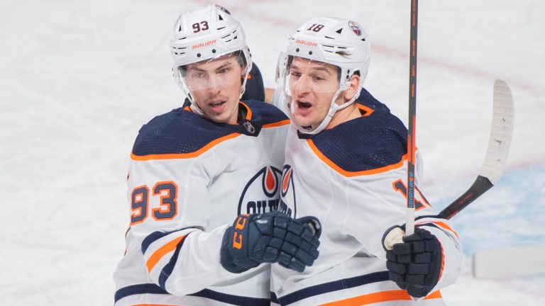 Edmonton Oilers' Zach Hyman (18) celebrates his goal with teammate Ryan Nugent-Hopkins (93) during first period NHL hockey action against the Montreal Canadiens, in Montreal, Saturday, Jan. 29, 2022. (Graham Hughes/CP)