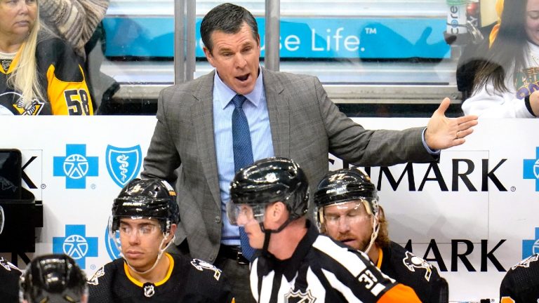 Pittsburgh Penguins head coach Mike Sullivan makes his point to referee Kevin Pollock (33) during the first period of an NHL hockey game against the Winnipeg Jets in Pittsburgh, Sunday, Jan. 23, 2022. The Penguins won in a shootout 3-2. (Gene J. Puskar/AP) 
