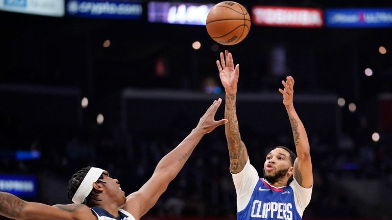 Los Angeles Clippers guard Xavier Moon, shoots as Minnesota Timberwolves forward Nathan Knight defends during the second half of an NBA basketball game Monday, Jan. 3, 2022, in Los Angeles. (Mark J. Terrill/AP) 