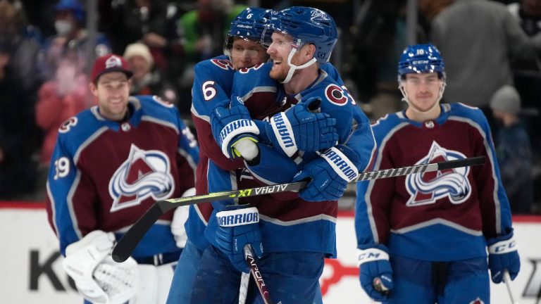 Colorado Avalanche left wing Gabriel Landeskog, front, is hugged by defenseman Erik Johnson. (David Zalubowski/AP) 