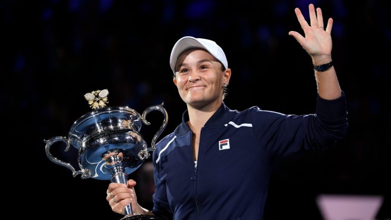 Ash Barty of Australia waves as she holds the Daphne Akhurst Memorial Cup after defeating Danielle Collins of the U.S., in the women's singles final at the Australian Open tennis championships in Saturday, Jan. 29, 2022, in Melbourne, Australia. (Andy Brownbill/AP)