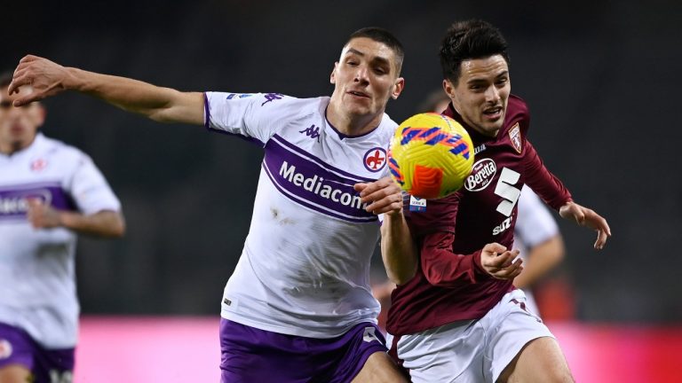 Torino's Josip Brekalo, right, and Fiorentina's Nikola Milenkovic battle for the ball during the Serie A soccer match between Torino and Fiorentina at the Olympic stadium in Turin, Italy, Monday, Jan. 10 2022. (Fabio Ferrari/LaPresse via AP)