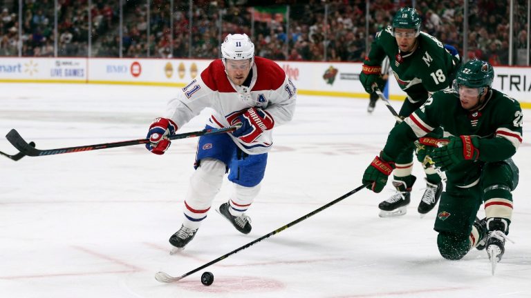 Minnesota Wild's Kevin Fiala (22) tries to gain control of the puck against Montreal Canadiens' Brendan Gallagher (11) in the second period of an NHL hockey game Sunday Oct. 20, 2019, in St. Paul, Minn. (Stacy Bengs/AP) 
