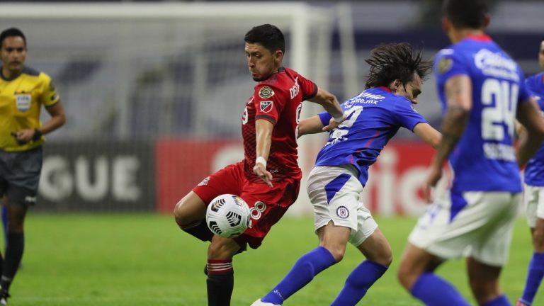 Mark Delgado of Canada's Toronto FC, centre, and Jose Martinez of Mexico's Cruz Azul compete for the ball during CONCACAF Champions League quarterfinal second leg soccer match at Azteca stadium in Mexico City, Tuesday, May 4, 2021. (Fernando Llano/AP)