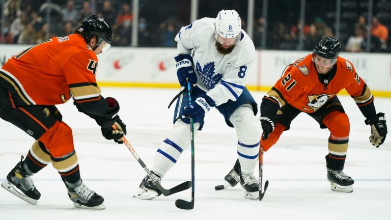 Toronto Maple Leafs' Jake Muzzin, centre, is defended by Anaheim Ducks' Cam Fowler, left, and Isac Lundestrom during the first period of an NHL hockey game Sunday, Nov. 28, 2021, in Anaheim, Calif. (Jae C. Hong/AP)