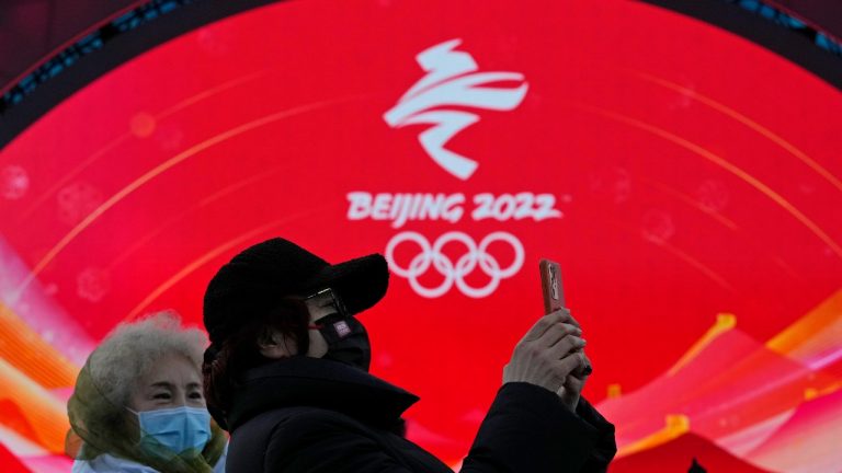 Staff members attend a rehearsal for a victory ceremony at the Beijing Medals Plaza of the Winter Olympics in Beijing, China, Monday, Jan. 3, 2022. (Ng Han Guan/AP Photo) 
