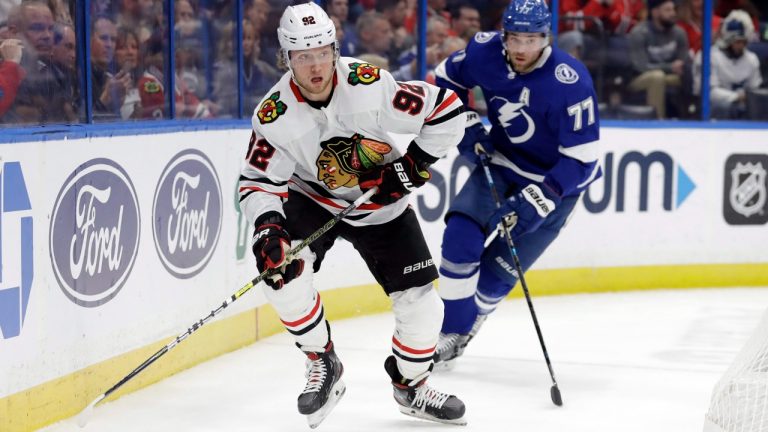 Chicago Blackhawks left wing Alex Nylander (92) looks to pass in front of Tampa Bay Lightning defenceman Victor Hedman (77) during the first period of an NHL hockey game Thursday, Feb. 27, 2020, in Tampa, Fla. (Chris O'Meara/AP)