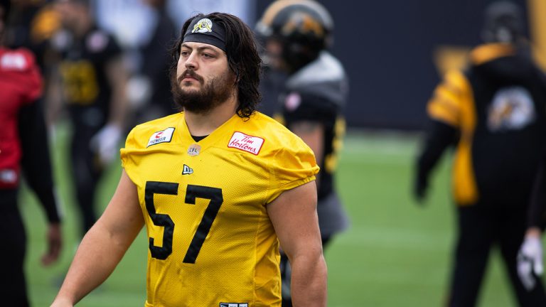 Hamilton Tiger-Cats offensive lineman Brandon Revenberg (57) takes part in a practice. (Nick Iwanyshyn/CP)