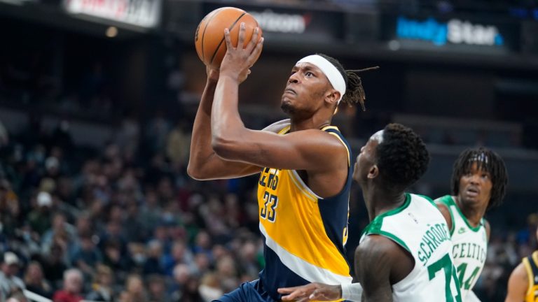 Indiana Pacers centre Myles Turner (33) puts up a shot over Boston Celtics guard Dennis Schroder (71) during the first half of an NBA basketball game, Wednesday, Jan. 12, 2022, in Indianapolis. (Darron Cummings/AP)