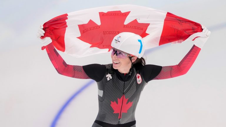 Canada's Ivanie Blondin celebrates her silver medal in the women's mass start speedskating final at the 2022 Winter Olympics in Beijing on Saturday, February 19, 2022. (CP)