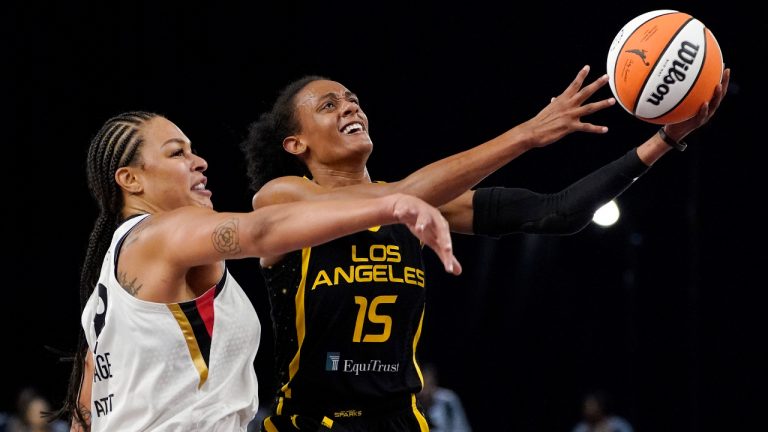 Los Angeles Sparks guard Brittney Sykes, right, shoots as Las Vegas Aces center Liz Cambage defends during the first half of a WNBA basketball game Friday, July 2, 2021, in Los Angeles. (AP Photo/Mark J. Terrill)