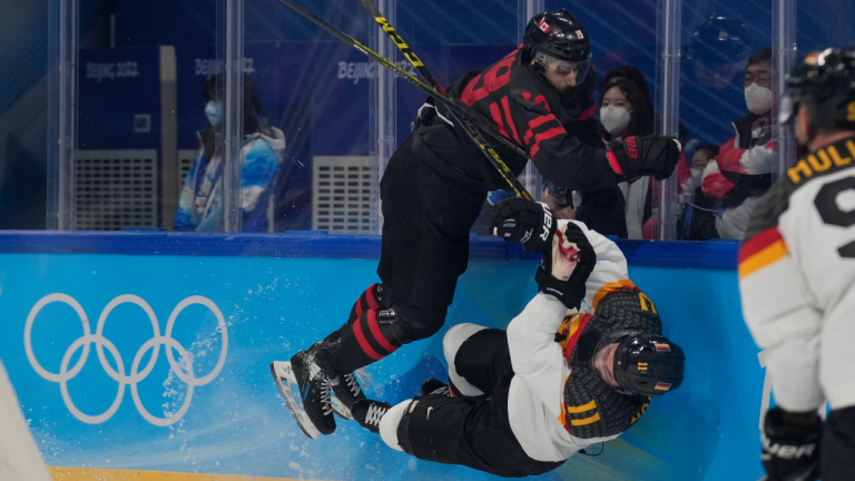 Canada's Eric O'Dell checks Germany's Marco Nowak during a preliminary round men's hockey game at the 2022 Winter Olympics, Thursday, Feb. 10, 2022, in Beijing. (AP)