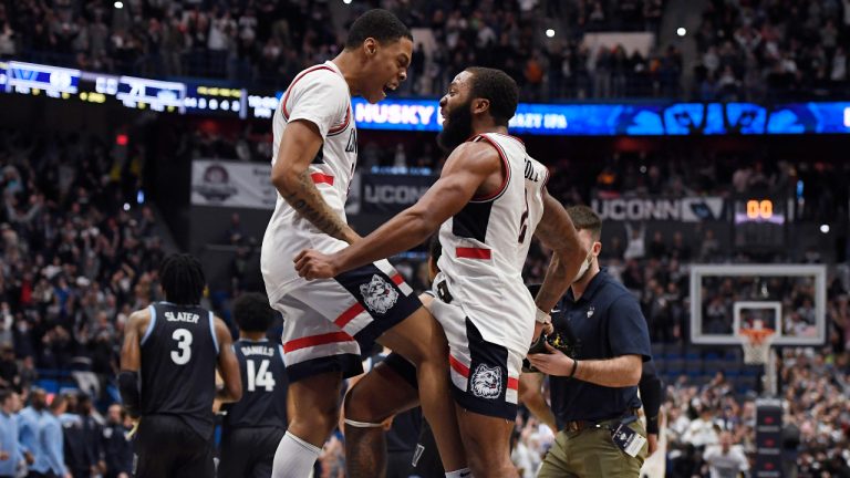 Connecticut's Jordan Hawkins, left, and R.J. Cole celebrate at the end of the team's NCAA college basketball game against Villanova, Tuesday, Feb. 22, 2022, in Hartford, Conn. (AP Photo/Jessica Hill)