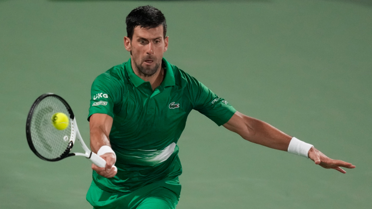 Serbia's Novak Djokovic returns the ball to Russia's Karen Khachanov during a match of the Dubai Duty Free Tennis Championship in Dubai, United Arab Emirates, Wednesday, Feb. 23, 2022. (Kamran/JeAP)