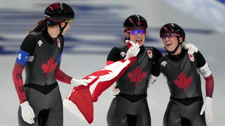 Team Canada, with Isabelle Weidemann left, Valerie Maltais centre, and Ivanie Blondin, react after wining the gold medal and setting an Olympic record in the speedskating women's team pursuit finals at the 2022 Winter Olympics, Tuesday, Feb. 15, 2022, in Beijing. (Ashley Landis/AP Photo)