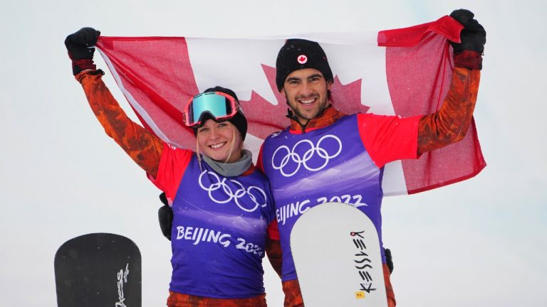 Canada's Meryeta O'Dine and Eliot Grondin celebrate their bronze medal in mixed team snowboard cross at the 2022 Beijing Winter Olympics in Zhangjiakou, China on Saturday, Feb. 12, 2022. (Sean Kilpatrick/CP)