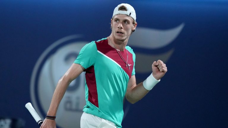 Denis Shapovalov celebrates a point win over Hungary's Marton Fucsovics during a match at the Dubai Duty Free Tennis Championship.(Ebrahim Noroozi/AP)