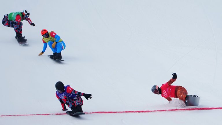 Austria's Alessandro Haemmerle crosses the finish line ahead of Canada's Eliot Grondin, right, Italy's Omar Visintin and Austria's Julian Lueftner in the men's snowboard cross final at the 2022 Beijing Winter Olympics in Zhangjiakou, China on Thursday, February 10, 2022. (Sean Kilpatrick/THE CANADIAN PRESS)