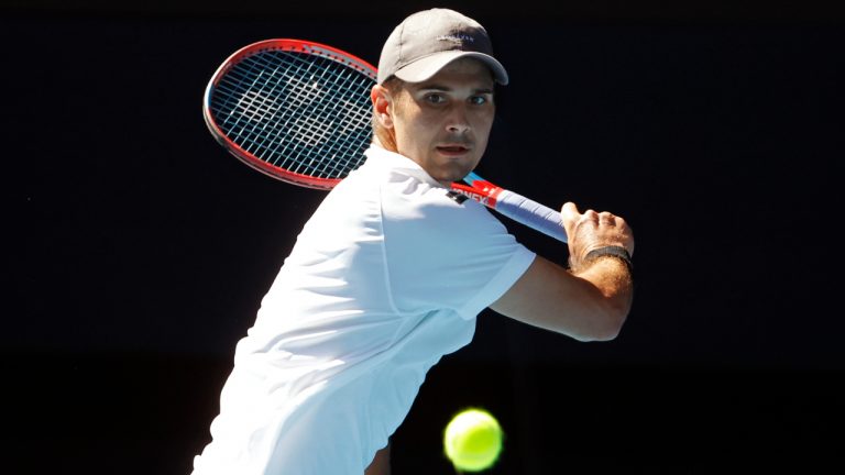 Marcos Giron of the U.S. plays a backhand return to Rafael Nadal of Spain during their first round match at the Australian Open tennis championships in Melbourne, Australia, Monday, Jan. 17, 2022. (Hamish Blair/AP)