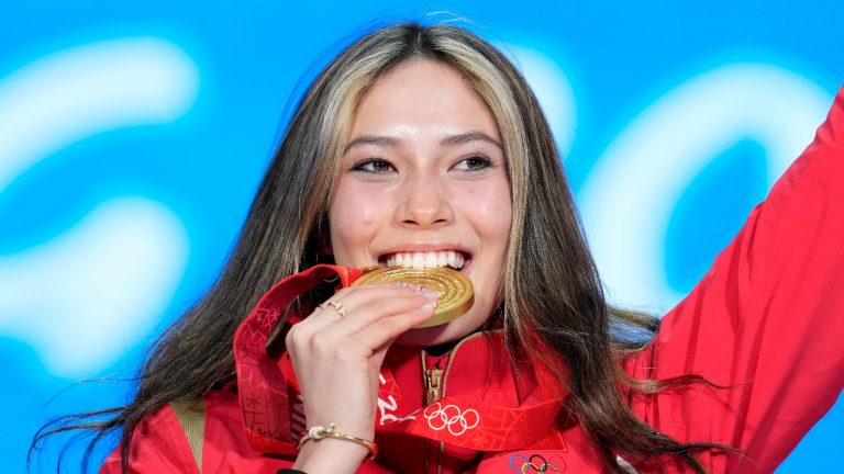 Gold medalist Eileen Gu of China celebrates during the medal ceremony for the women's freestyle skiing big air at the 2022 Winter Olympics, Tuesday, Feb. 8, 2022, in Beijing. (Natacha Pisarenko/AP Photo)