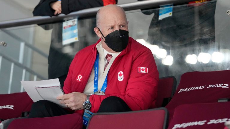 Team Canada head coach Claude Julien takes notes before the team’s game against Germany, Thursday, February 10, 2022 at the 2022 Winter Olympics in Beijing. Julien will be back behind the bench for the next game after arriving late in Beijing due to an injury. (Ryan Remiorz/THE CANADIAN PRESS)