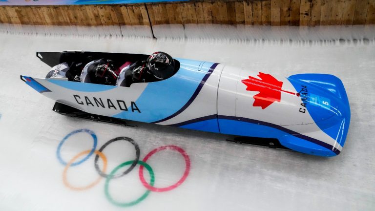 Justin Kripps, Ryan Sommer, Cam Stones and Benjamin Coakwell, of Canada, slide during the 4-man heat 3 at the 2022 Winter Olympics, Sunday, Feb. 20, 2022, in the Yanqing district of Beijing. (Dmitri Lovetsky/AP Photo)