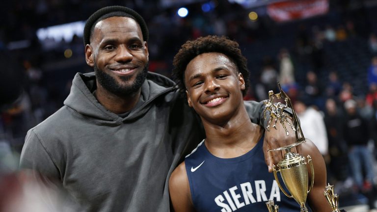 LeBron James, left, poses with his son Bronny after Sierra Canyon beat Akron St. Vincent - St. Mary in a high school basketball game. (Jay LaPrete/AP)