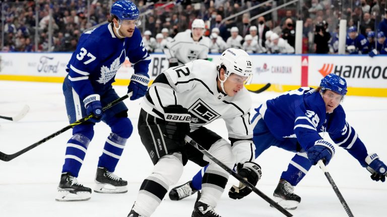 Toronto Maple Leafs defenceman Timothy Liljegren (37) and teammate Rasmus Sandin (38) try to defend as Los Angeles Kings centre Trevor Moore (12) makes his way to the net during first period NHL hockey action in Toronto, Monday, Nov. 8, 2021. (Frank Gunn/CP)