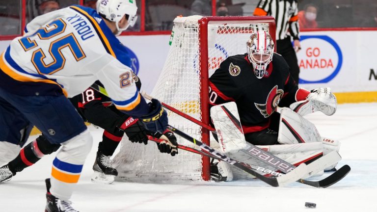 Ottawa Senators goaltender Matt Murray (30) watches the puck as St. Louis Blues centre Jordan Kyrou (25) tries to get past Ottawa Senators left wing Tim Stutzle (18) during first period NHL hockey action in Ottawa, on Tuesday, Feb. 15, 2022. (Justin Tang/CP)