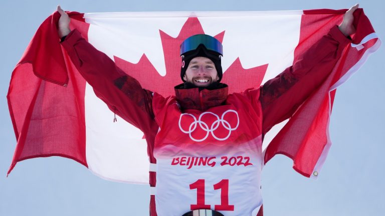 Canada's Max Parrot, of Bromont, Que., celebrates his gold medal performance on the podium following the men's slopestyle final at the Beijing Winter Olympic Games, in Zhangjiakou, China, Monday, Feb. 7, 2022.  (Sean Kilpatrick/THE CANADIAN PRESS)