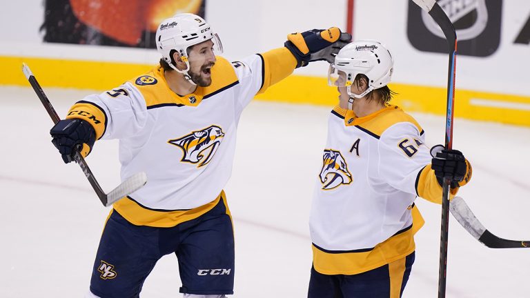 Nashville Predators left wing Filip Forsberg, left, celebrates with center Mikael Granlund after Granlund scored during the third period of an NHL hockey game. (Wilfredo Lee/AP)