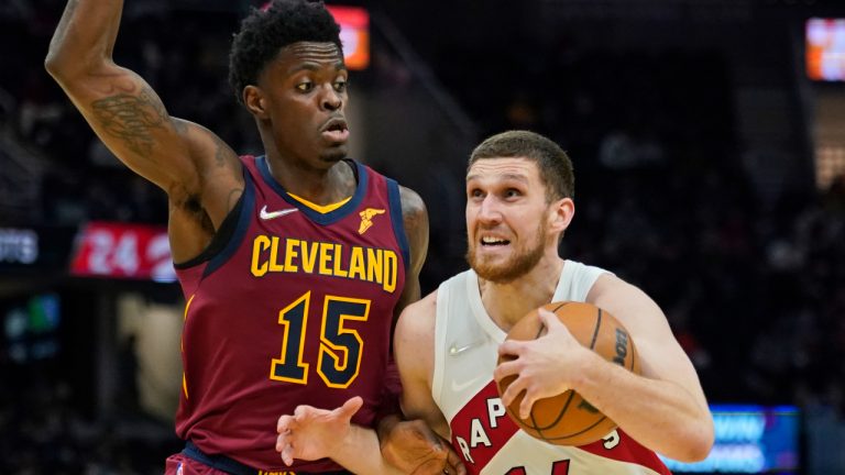 Toronto Raptors' Svi Mykhailiuk (14) drives against Cleveland Cavaliers' Tre Scott (15) in the second half of an NBA basketball game, Sunday, Dec. 26, 2021, in Cleveland. (Tony Dejak/AP)