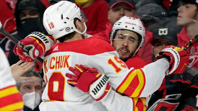 Calgary Flames left wing Johnny Gaudreau, right, celebrates his goal with left wing Matthew Tkachuk (19) during the third period of an NHL hockey game against the Carolina Hurricanes, Friday, Jan. 7, 2022, in Raleigh, N.C. (AP Photo/Chris Seward)