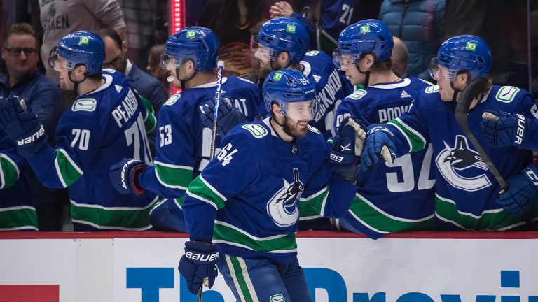 Vancouver Canucks' Tyler Motte (64) celebrates his goal against the Seattle Kraken during the first period of an NHL hockey game. (Darryl Dyck/CP)