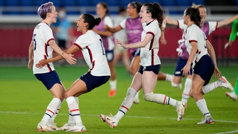 United States' Megan Rapinoe, left, celebrates with teammates after scoring the winning goal and defeating the Netherlands in a penalty shootout during a women's quarterfinal soccer match at the 2020 Summer Olympics, Friday, July 30, 2021, in Yokohama, Japan. (Silvia Izquierdo/AP)