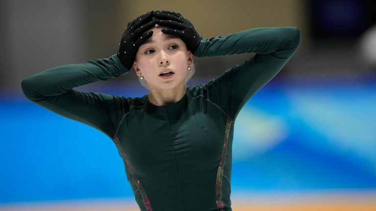 Kamila Valieva, of the Russian Olympic Committee, puts her hands on her head during a training session at the 2022 Winter Olympics, Sunday, Feb. 13, 2022, in Beijing. (AP Photo/David J. Phillip)